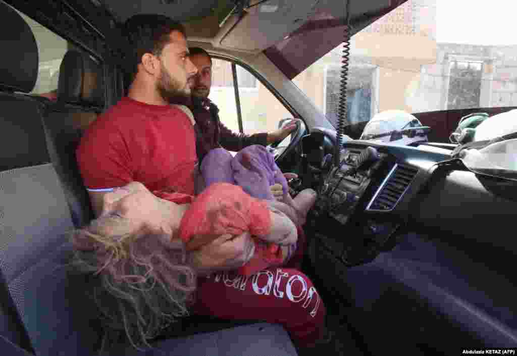 A wounded Syrian girl is transferred to a hospital following a reported air strike by regime forces and their allies on Maaret al-Noman in the southwestern Idlib Province on May 30. (AFP/Abdulaziz Ketaz)