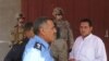 Najim (far right) confers with police and U.S. troops after a violent incident in Salahaddin Province. (Photo by Richard Tomkins)