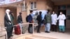 Afghan health officials screen people entering Afghanistan from Iran at the border in Herat Province last month.