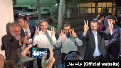 Iranian former president Mahmoud Ahmadinejad (C) and his close advisors Hamid Baghaei (R) and Esfandiar Rahim Mashei (3rd L).