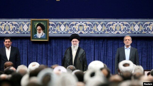 Iran's Supreme Leader Ayatollah Ali Khamenei and new President Masoud Pezeshkian attend an endorsement ceremony in Tehran, July 28, 2024.