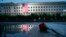 A U.S. flag is unfurled at sunrise on September 11 at the Pentagon on the 17th anniversary of the terrorist attacks.