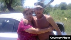 Armenia - Soldier Hakob Injighulian poses for a photograph with his mother during military service.