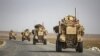 U.S. military vehicles drive on a road after U.S. forces pulled out of their base in the Northern Syrian town of Tal Tamr, October 20, 2019