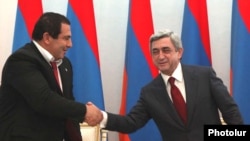 Armenia -- Prosperous Armenia Party leader Gagik Tsarukian (L) and President Serzh Sarkisian sign a joint declaration pledging support for the latter's reelection bid, 17Feb2011.