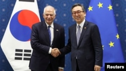 South Korean Foreign Minister Cho Tae-yul (right) shakes hands with European Union foreign policy chief Josep Borrell prior to a meeting at the Foreign Ministry in Seoul on November 4.