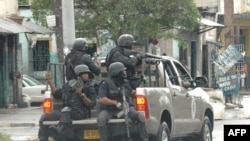 Police patrol downtown Kingston early on in the three-day standoff.