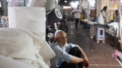 A man sits at a local market in Bandar Abbas, Iran, on August 25.