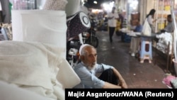 A man sits at a local market in Bandar Abbas, Iran, on August 25.