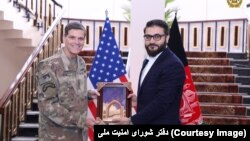 FILE: Afghan National Security Adviser Hamdullah Mohib (L) with General Joseph Votel, head of U.S. Central Command (CENTCOM) in February.