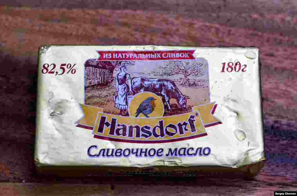 Hansdorf butter, made in St. Petersburg, adopts a German-style appearance, its label showing a bluebird, a smiling milkmaid, and a grass-fed cow.