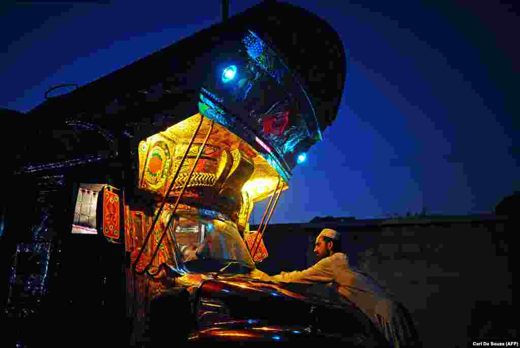 A truck painter buffs the bodywork of a truck in Noor's workshop. According to The New York Times, the price of fully decorating a truck can easily reach $25,000. 