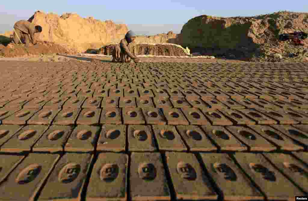 A woman makes mud bricks at a brick factory on the outskirts of Islamabad. (Reuters/Faisal Mahmood)