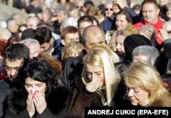 Oliver Ivanovic's widow, Milena (left), attends her husband's funeral in Belgrade on January 18.