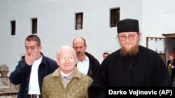 Kosovo Liberation Army political leader Adem Demaci (left) meets with father Sava Janjic at the Decani monastery in October 1998.