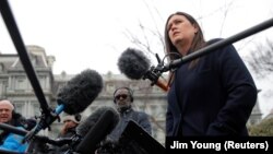 White House press secretary Sarah Sanders speaks to reporters outside the White House in Washington.