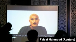Former Indian Navy officer Kulbhushan Sudhir Jadhav is seen on a screen during a news conference in Pakistan.