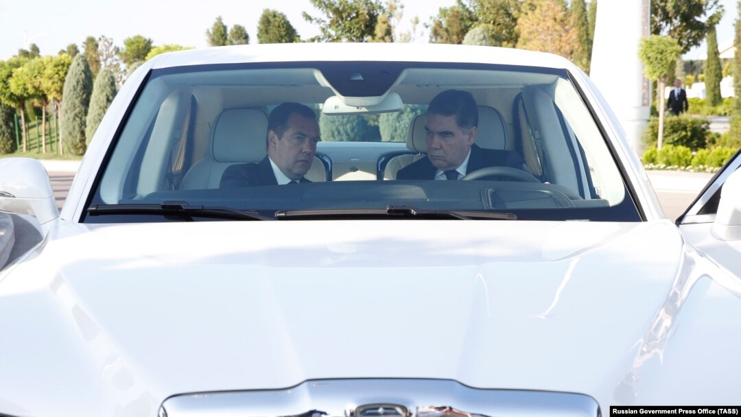 Medvedev and Berdymukhammedov sit inside a Russian-made limousine at the Caspian Economic Forum.