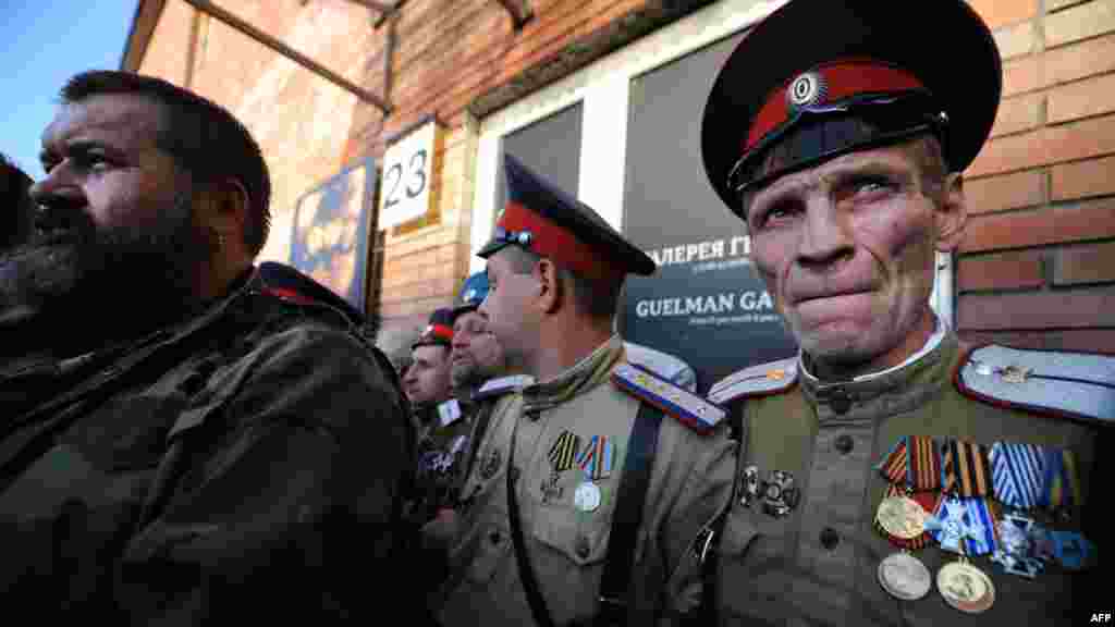 Cossacks block the entrance as they protest in front of the Winzavod art gallery during the opening of the "Spiritual Abuse" painting exhibition by the artist Yevgenia Maltseva in Moscow. (AFP/Andrey Smirnov)