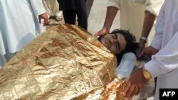 Men carry a bombing victim into a hospital following an attack on the home of militant commander Mullah Nabi Hanafi in northwestern Pakistan. 