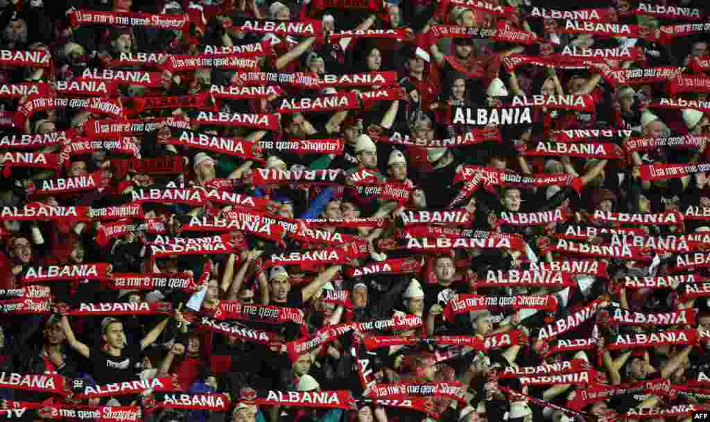 Albanian fans cheer prior to a Euro 2016 Group I qualifying football match between Albania and Serbia in Elbasan. Some 2,300 police officers weren mobilized to secure the safety of the visiting team and to prevent any incidents that might mar the match on October 8. Serbia won 2-0. (AFP/Gent Shkullaku)