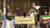 Women holding a sign, saying “After the election can I still come to the stadium?” Many had sent tweets to Rouhani telling him that this should not be the first and last time women are allowed to enter a stadium.