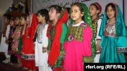 Afghan children singing the national anthem at an event for World Children's Day. Under the new ban by the Education Ministry, schoolgirls over a certain age will only be permitted to sing at public events if all participants are female. (file photo)