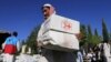 An Afghan man receives aid from the International Federation of the Red Cross and Red Crescent Societies after an earthquake in the Behsud district of Jalalabad Province in October 2015.