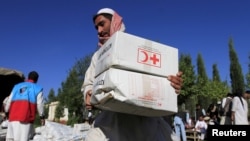 An Afghan man receives aid from the International Federation of the Red Cross and Red Crescent Societies after an earthquake in the Behsud district of Jalalabad Province in October 2015.