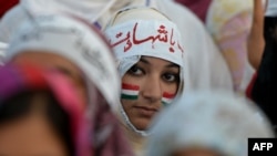 Pakistani supporters of Tahir-ul-Qadri listen to their leader's speech in front of the Parliament during an anti-government protest in Islamabad on August 28, 2014.