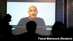 Former Indian Navy officer Kulbhushan Sudhir Jadhav is seen on a screen during a news conference in Pakistan.