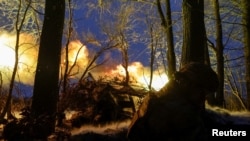 A soldier of the National Guard of Ukraine fires a howitzer toward Russian troops at a position on a front line in the Kharkiv region on January 6.