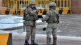 Kazakh law enforcement officers stand guard in Nur-Sultan