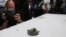 Journalists take pictures of a magnet the U.S. Navy says came from a limpet mine that didn't explode on a Japanese-owned oil tanker at a 5th Fleet base, during a trip organized by the Navy for journalists, near Fujairah, United Arab Emirates, Wednesday, J