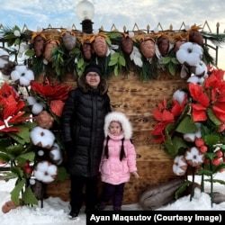 Ayan Maqsutov poses with his daughter in Oskemen, eastern Kazakhstan.