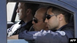 Iranian agent Ali Vakili Rad (center) in a police vehicle lleaving Poissy prison, in a Paris suburb, on May 18.
