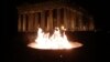 An Olympic flame is lit at an altar during the torch relay of the Sochi 2014 Winter Olympics in front of the Parthenon at the Acropolis hill in Athens. (Reuters/Yorgos Karahalis)