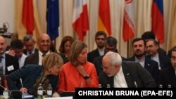 European officials and Foreign Minister of Iran Mohammad Javad Zarif attend a ministerial meeting of the Joint Commission of the JCPOA.