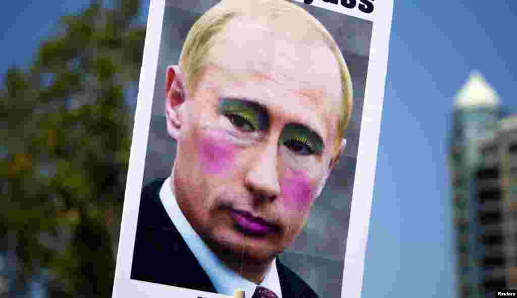 A sign featuring the defaced picture of Russian President Vladimir Putin is seen during Vancouver&#39;s 35th annual Pride Parade. (Reuters/Ben Nelms)