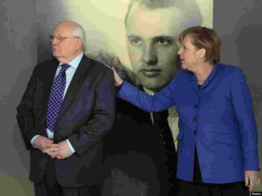 With German Chancellor Angela Merkel at an exhibition marking Gorbachev's 80th birthday at the Kennedy Museum in Berlin on February 24, 2011. 