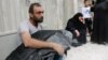 A Syrian man carries the body of his nephew following a reported air strike in Aleppo on September 23.