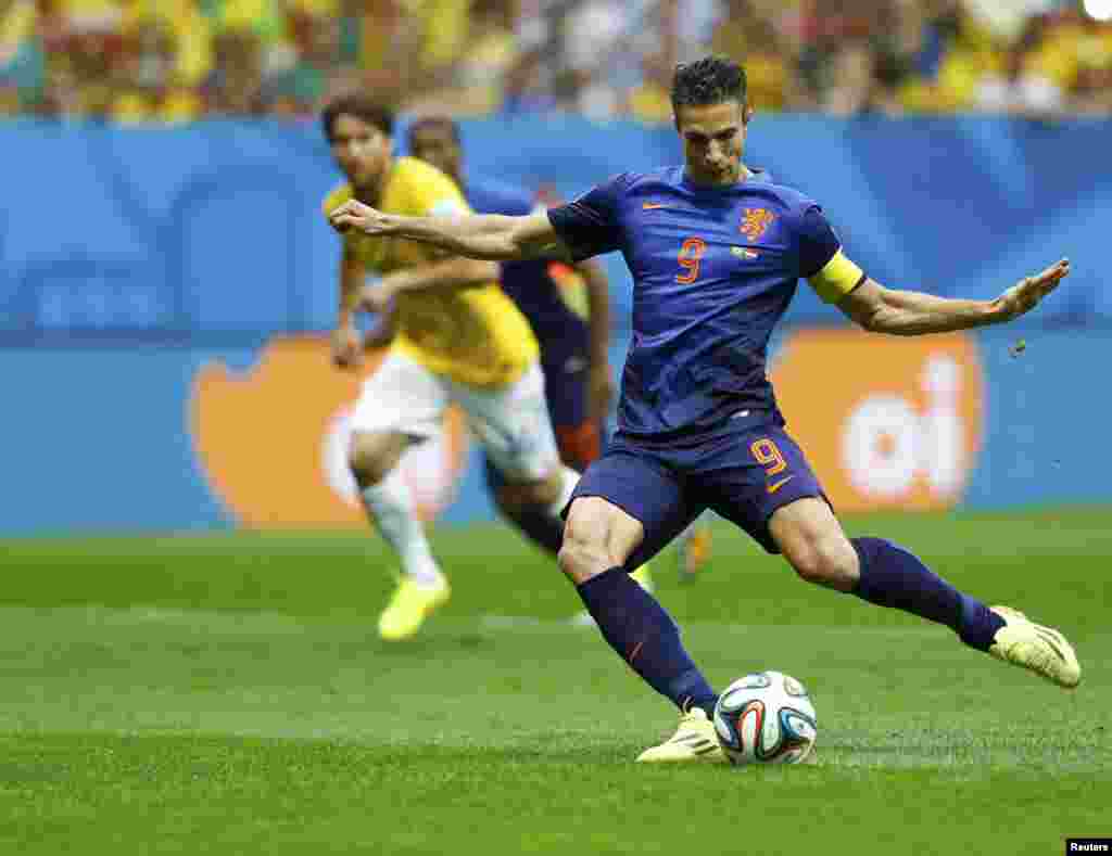 Robin van Persie of the Netherlands scores from a penalty kick during their 2014 World Cup third-place playoff against Brazil at the Brasilia national stadium in Brasilia July 12, 2014