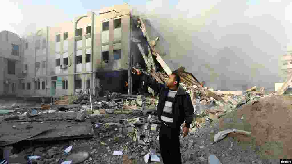 A member of Hamas security forces points to an unexploded missile (not seen) after an Israeli air strike on the building of the Hamas Interior Ministry in Gaza City. (Reuters/Mohammed Salem)