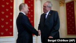 Russian President Vladimir Putin (left) welcomes Czech Republic President Milos Zeman during a ceremony in the Kremlin prior to the Victory Parade marking the 70th anniversary of the defeat of the Nazis in World War II in May 2015.