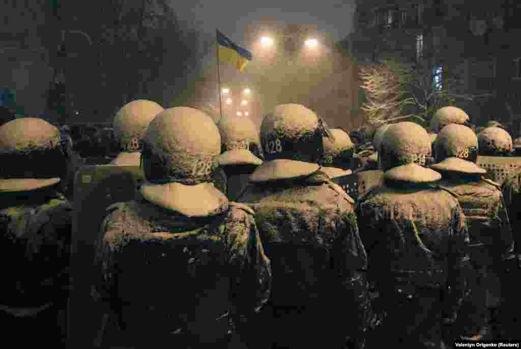 Interior Ministry troops block protesters on a city street. 