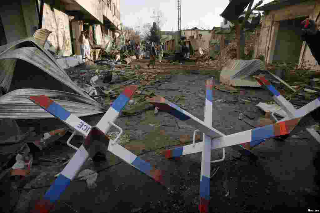 People inspect the damage in Quetta the day after the attacks.