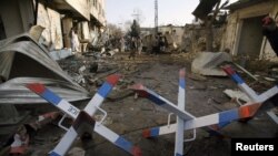 People inspect the site of one of the bomb blasts in Quetta that killed more than 80 people on January 10. 