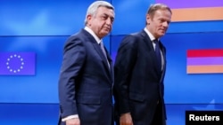 Belgium - Armenia's President Serzh Sarkisian (L) walks next to European Council President Donald Tusk after a joint news statement in Brussels, February 27, 2017