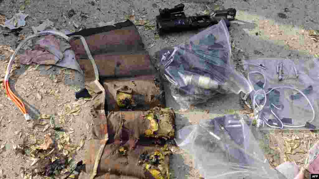 Weapons found at the scene include a grenade launcher, a gun, and part of the exploded vest of the suicide attacker.