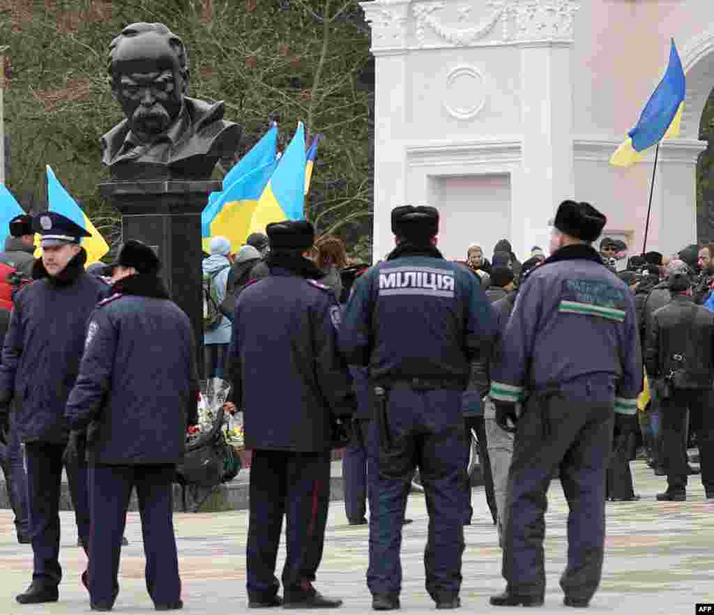 Полицейские наблюдают за митингом проукраинских активистов у памятника Тараса Шевченко, 11 марта 2014